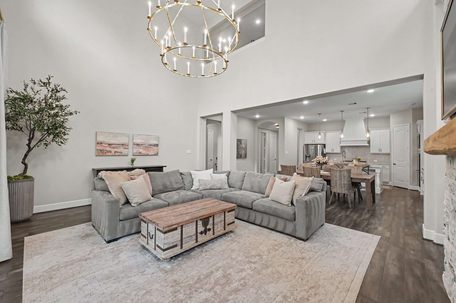 Two story living room with designer chandelier from Visual Comfort