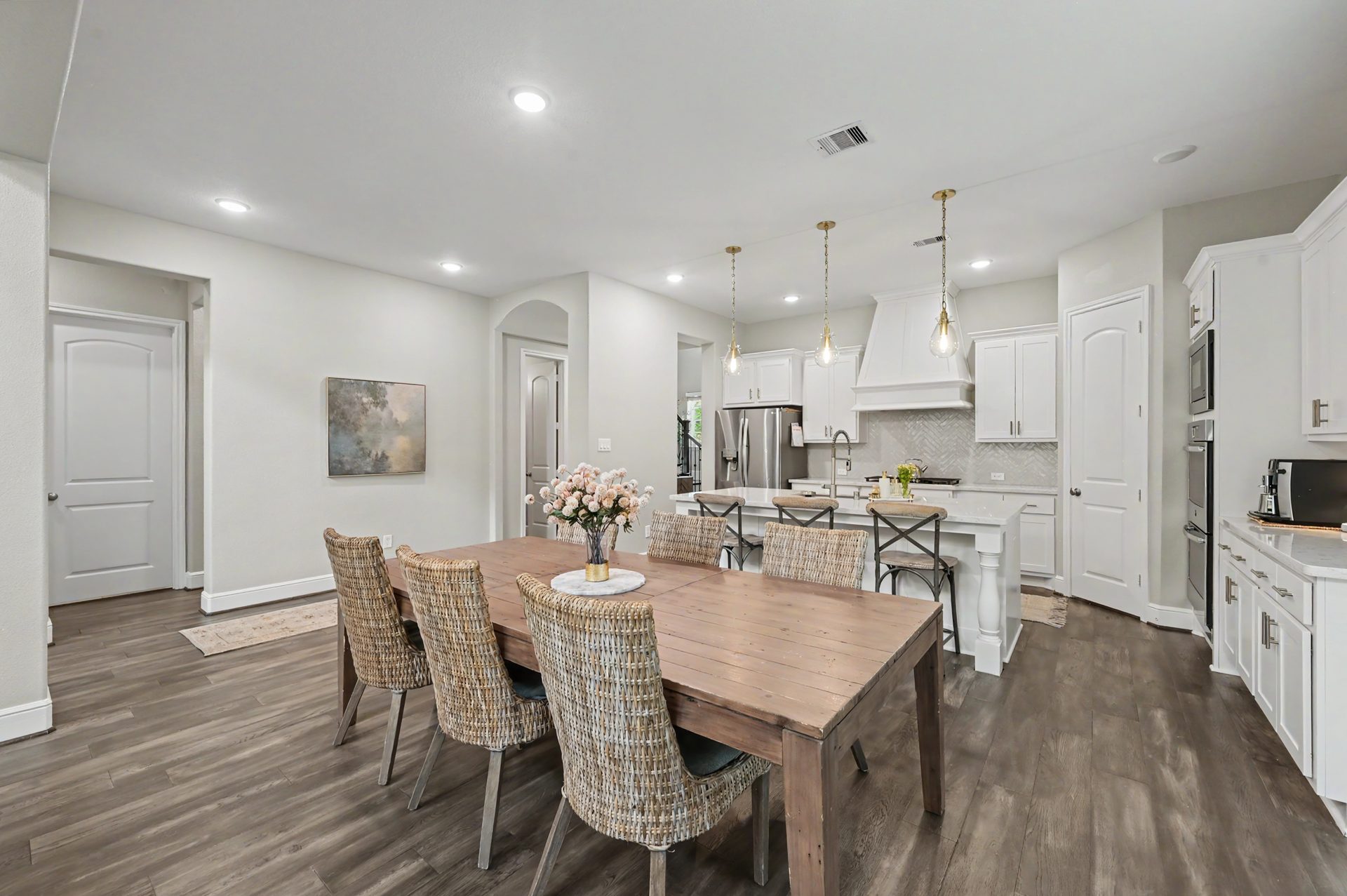 Sun-filled dining area with wide plank flooring