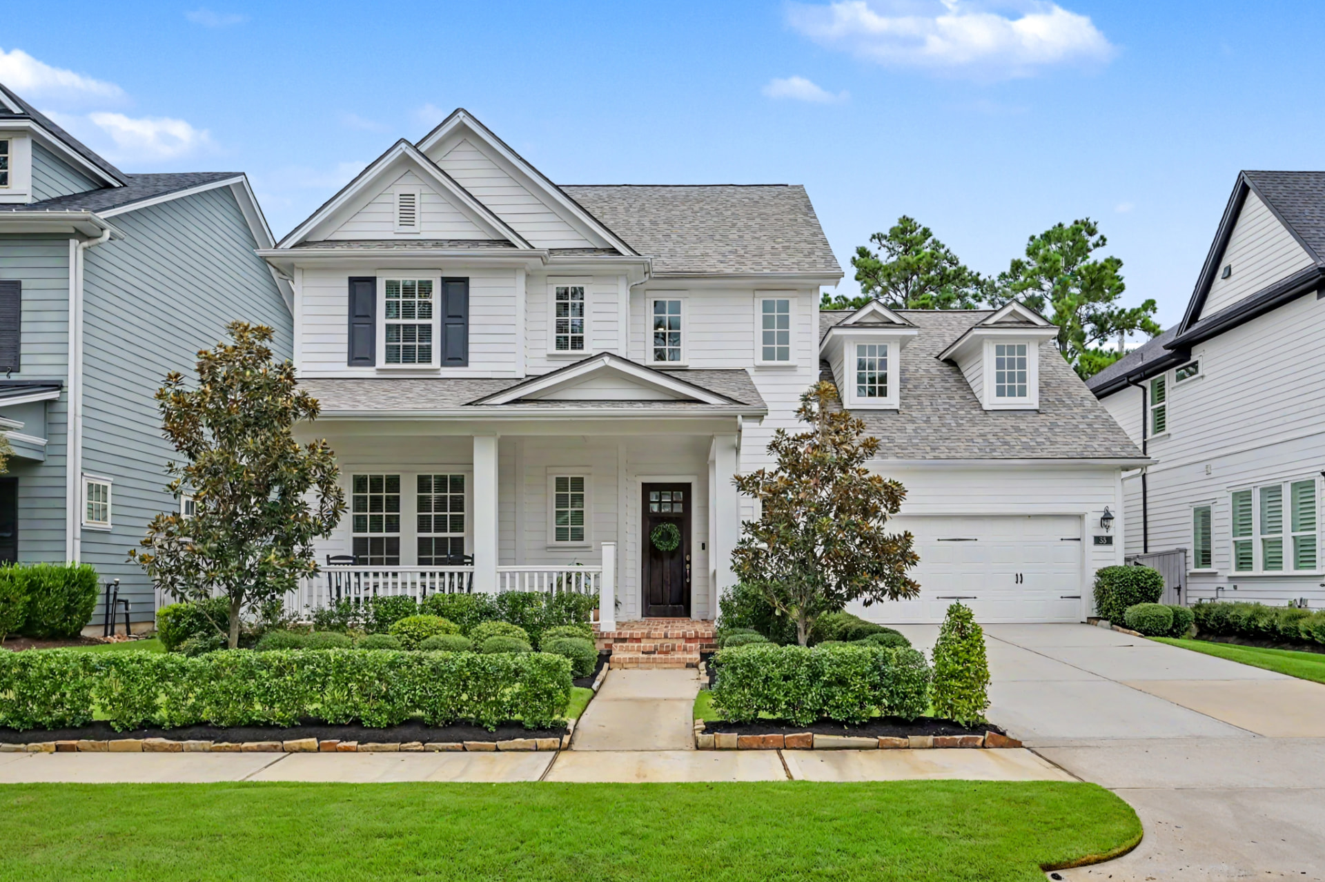 Charming front elevation with manicured landscaping