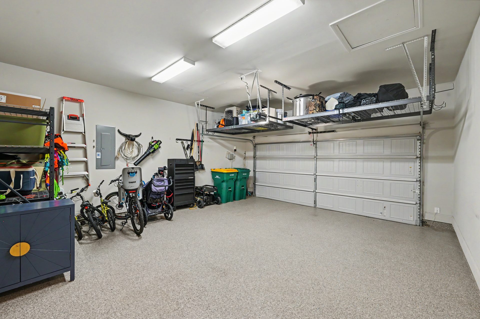 Oversized two car garage with overhead storage and upgraded epoxy flooring