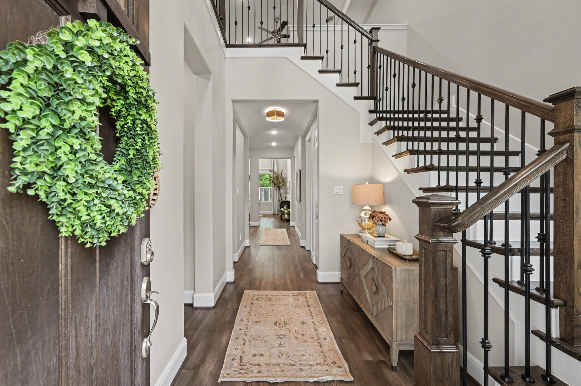 Bright entry with wrought-iron staircase