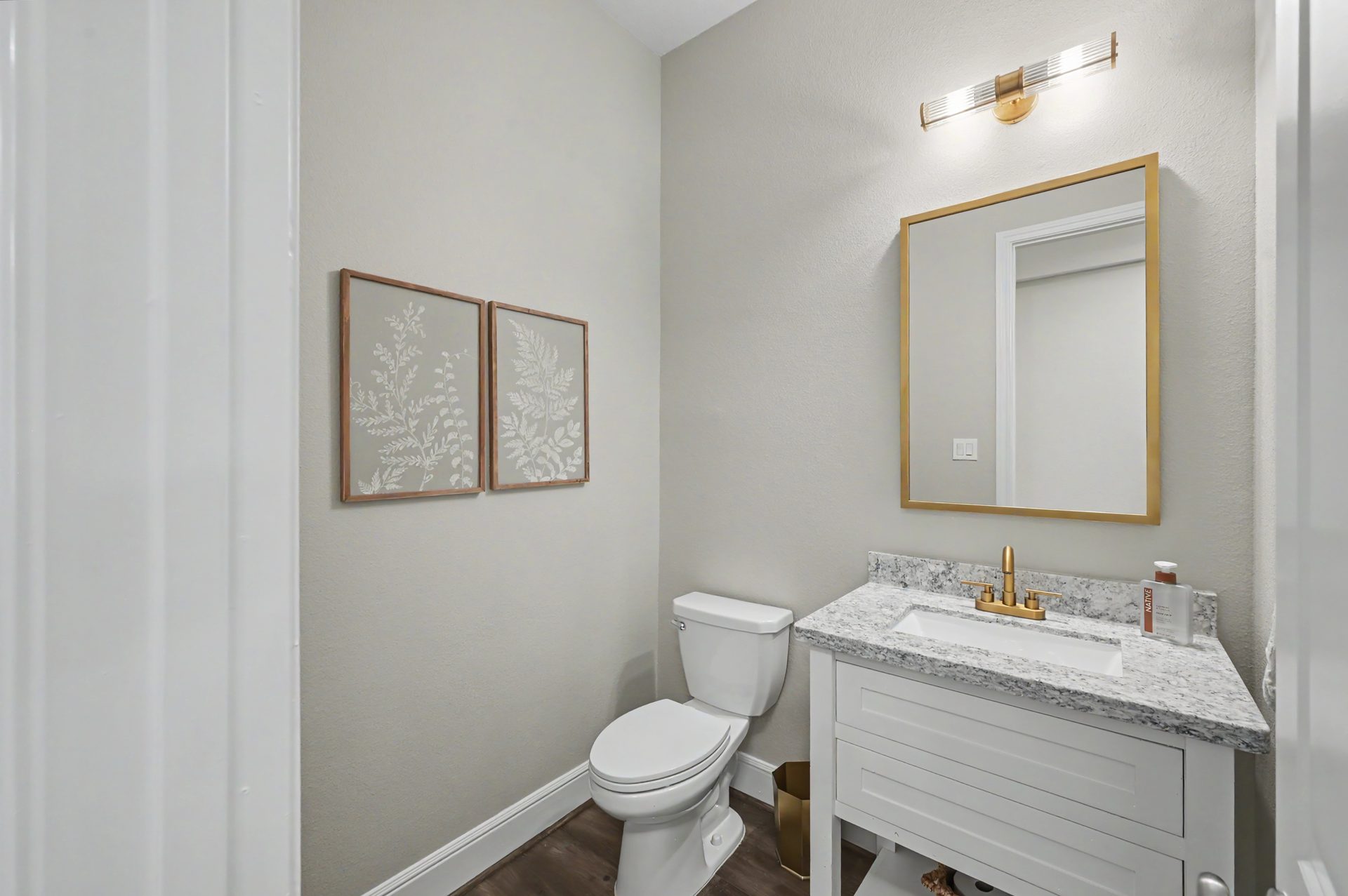 Elegant powder bath with Visual Comfort lighting and upgraded faucet 