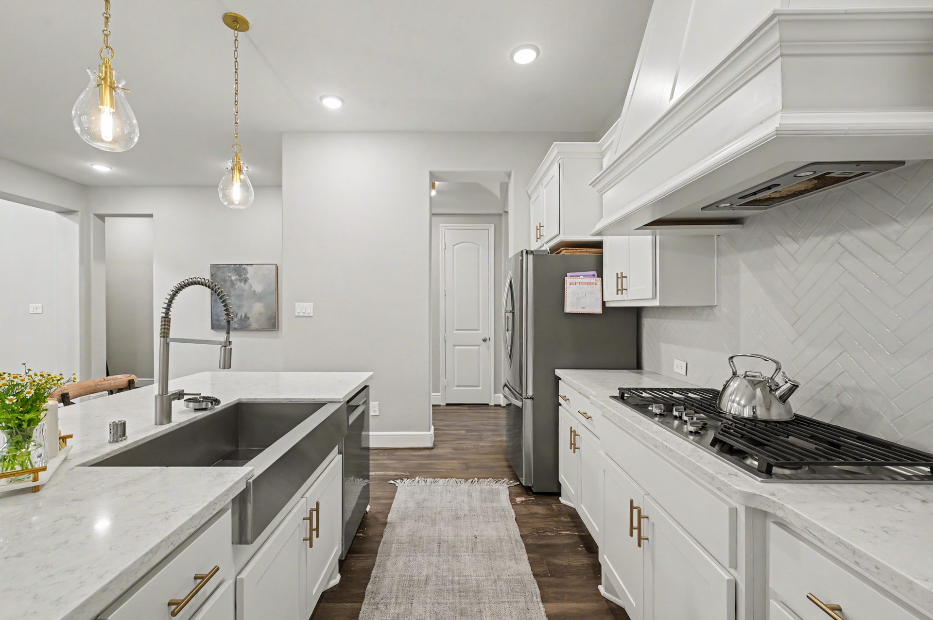 Farmhouse sink and herringbone backsplash